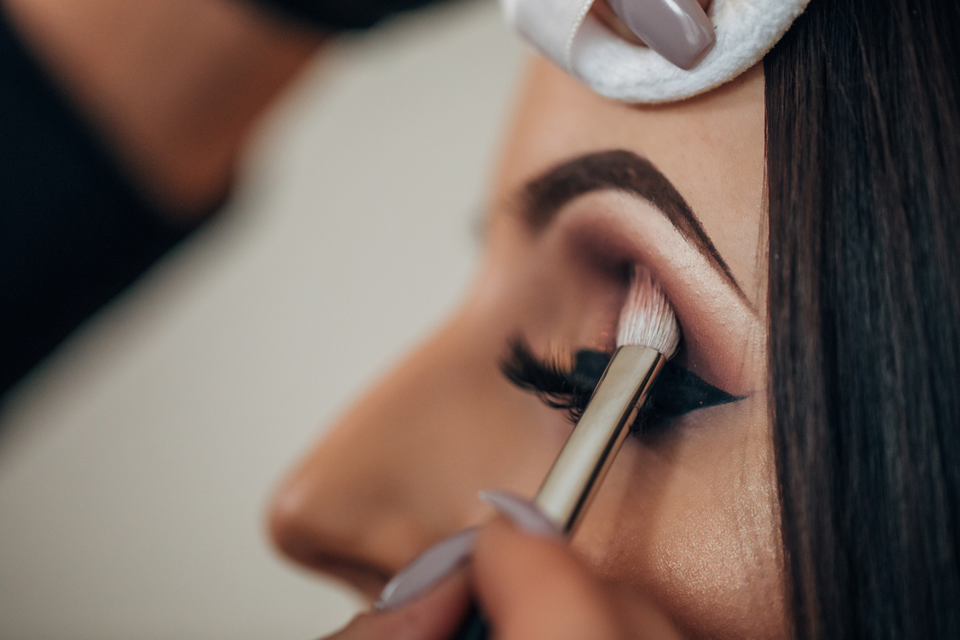 Makeup artist applying eye makeup